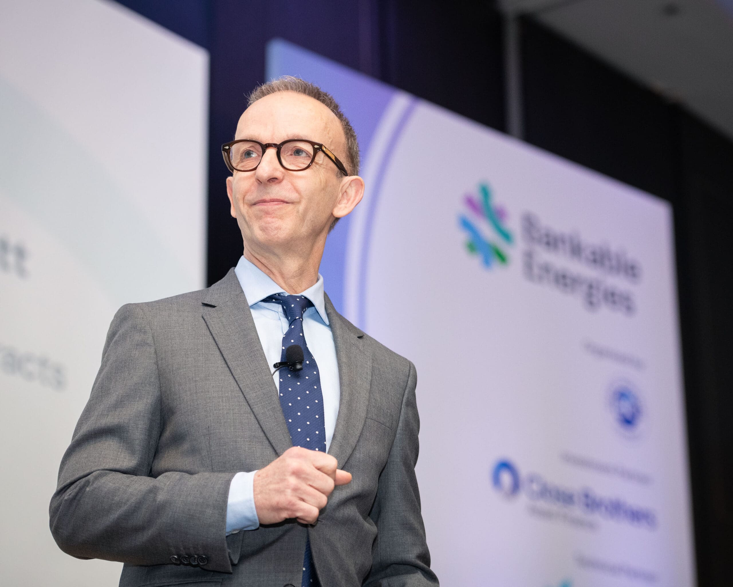 Man in suit on stage at business conference